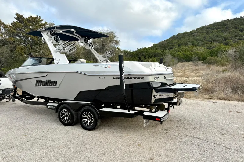 Slide: The Image of 2021 Malibu Wakesetter 25 LSV boat on trailer, parked outdoors. - 9