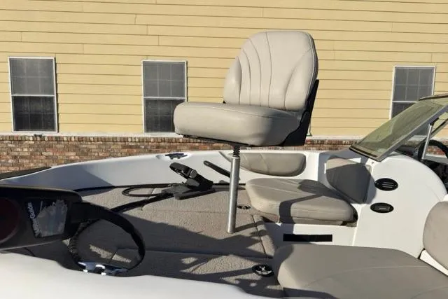 Slide: The Image of 2002 Triton SF-21 boat interior with beige seating and steering wheel. - 5