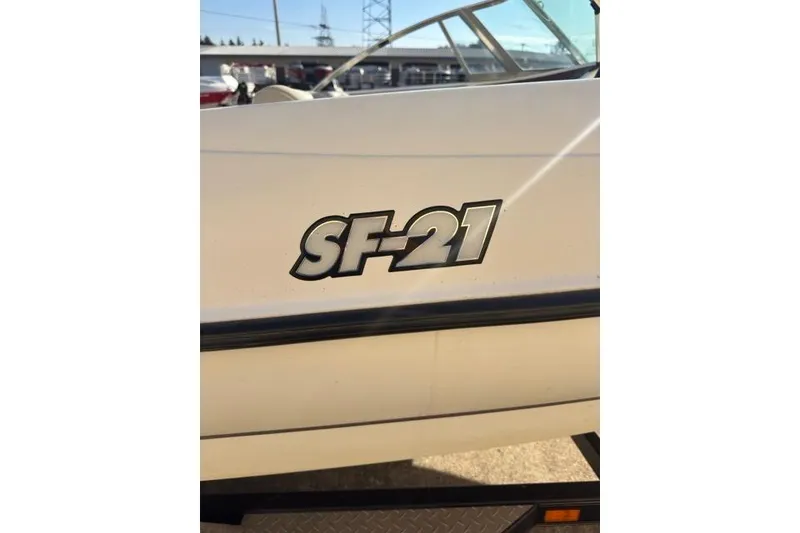 Slide: The Image of 2002 Triton SF-21 boat model emblem on white exterior. - 9