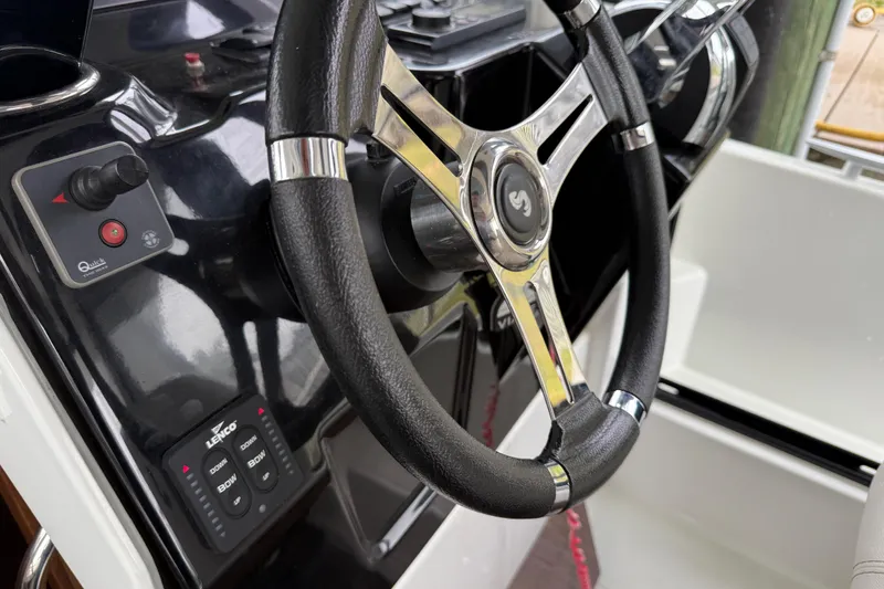 Slide: The Image of Steering wheel of 2020 Beneteau Antares 9 boat, featuring control panel and joystick. - 14