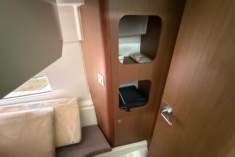Slide: The Image of Interior cabin of 2020 Beneteau Antares 9 with wooden storage and window. - 20