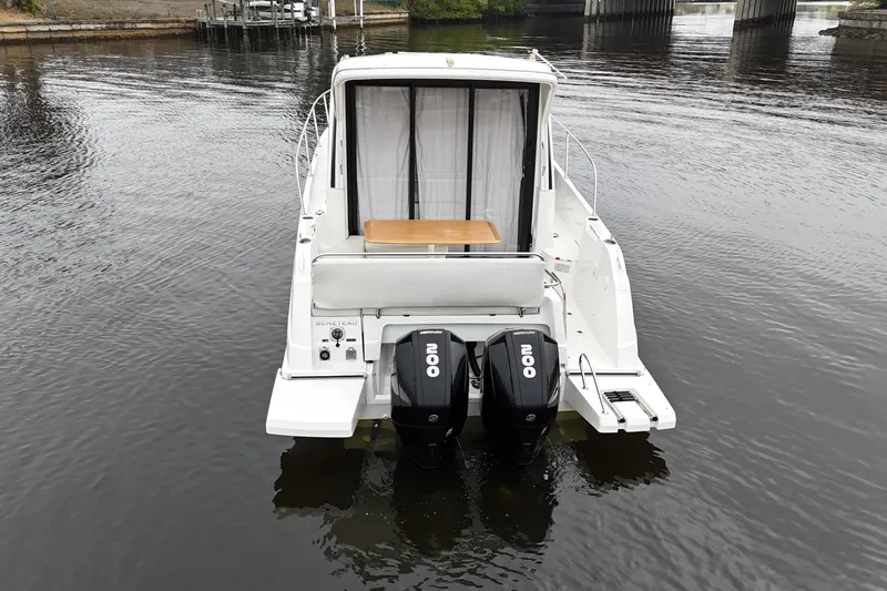 Slide: The Image of 2020 Beneteau Antares 9 boat with dual Mercury outboard engines on calm water. - 4