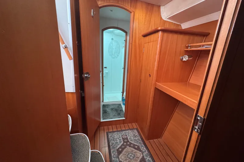 Slide: The Image of Interior of 2000 Lagoon 380 yacht with wooden cabinetry and bathroom view. - 17