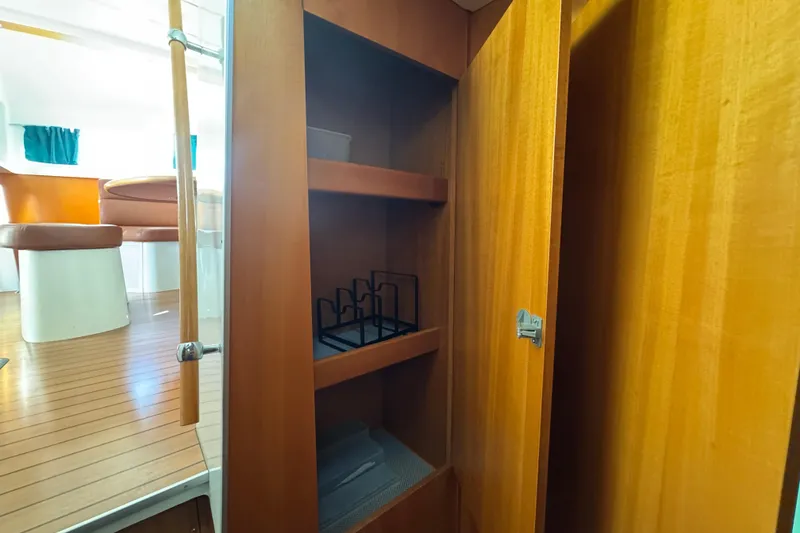 Slide: The Image of Interior of 2000 Lagoon 380 yacht with wooden cabinetry and seating area. - 18