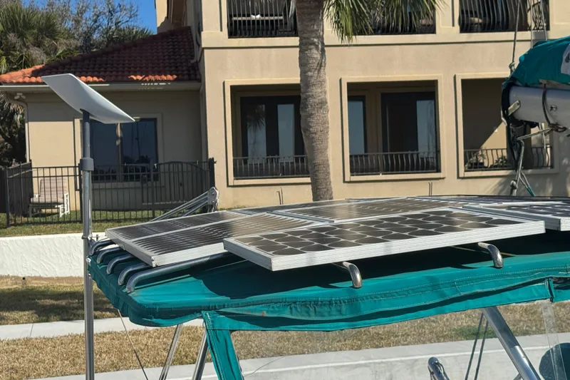 Slide: The Image of Solar panels on Lagoon 380 catamaran, 2000 model, with a satellite dish nearby. - 24