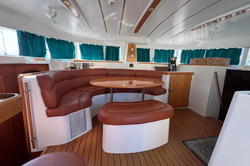 Slide: The Image of Interior of 2000 Lagoon 380 catamaran with leather seating and wooden accents. - 29