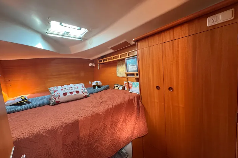 Slide: The Image of Cozy cabin interior of 2000 Lagoon 380 catamaran with wood paneling and skylight. - 4