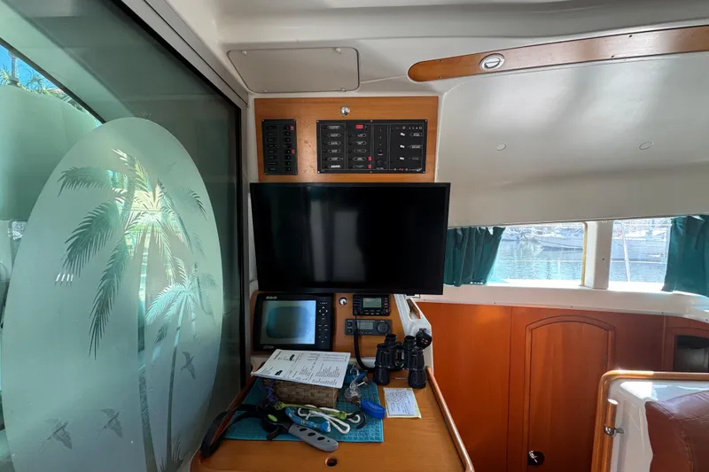 Slide: The Image of Interior of 2000 Lagoon 380 catamaran with navigation equipment and palm tree window design. - 5