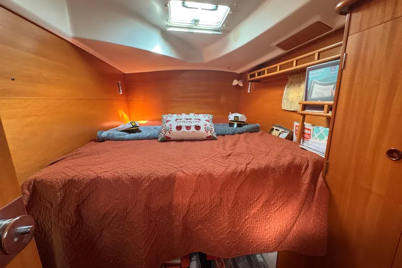 Slide: The Image of Cozy cabin interior of 2000 Lagoon 380 catamaran with wooden finish and comfortable bedding. - 9