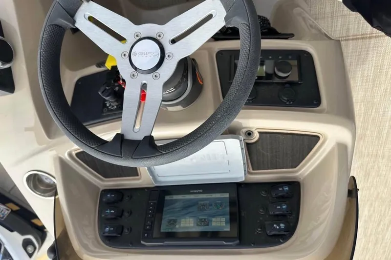 Slide: The Image of Steering console of 2022 Manitou 25 AURORA LE RF boat with control panel and display. - 5