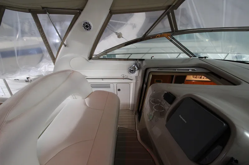 Slide: The Image of Interior view of 2000 Sea Ray 410 Sundancer yacht cockpit with seating and controls. - 15