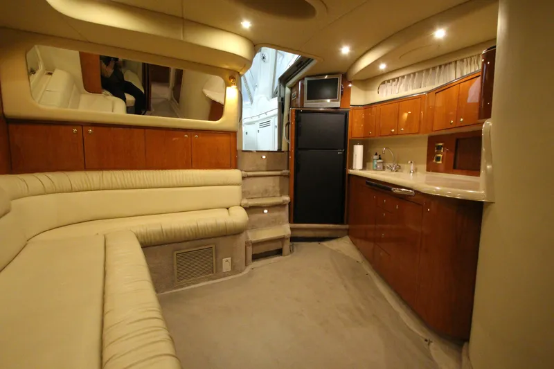 Slide: The Image of Luxurious interior of a 2000 Sea Ray 410 Sundancer yacht with plush seating and kitchenette. - 22