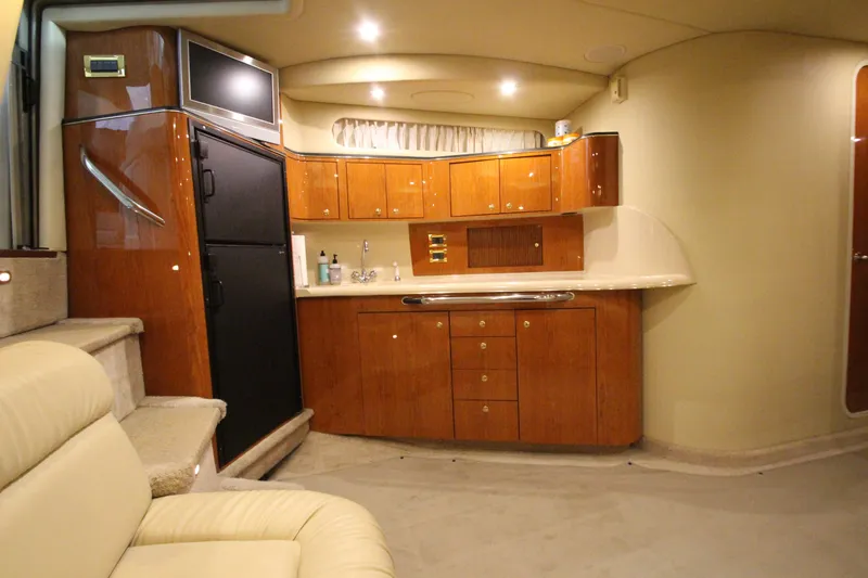 Slide: The Image of Luxurious interior of 2000 Sea Ray 410 Sundancer yacht with wood cabinetry and modern amenities. - 23
