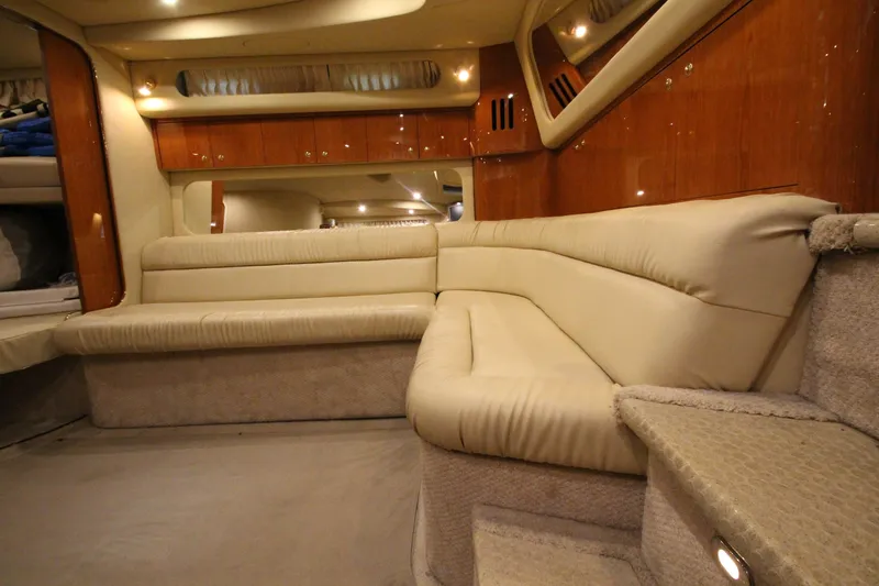 Slide: The Image of Luxurious interior of 2000 Sea Ray 410 Sundancer yacht with plush seating and wood accents. - 25
