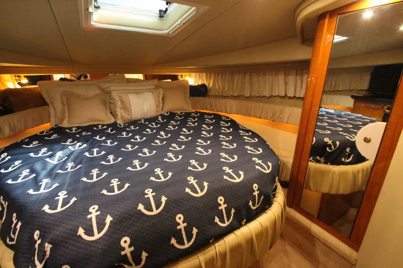 Slide: The Image of Luxurious cabin interior of 2000 Sea Ray 410 Sundancer with nautical-themed bedding. - 31