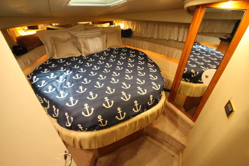 Slide: The Image of Luxurious cabin interior of 2000 Sea Ray 410 Sundancer with nautical-themed bedding. - 32