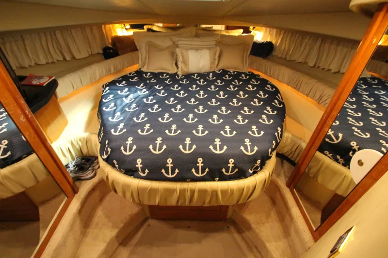 Slide: The Image of Luxurious cabin interior of 2000 Sea Ray 410 Sundancer with anchor-themed bedding. - 33