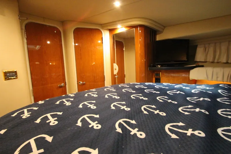 Slide: The Image of Luxurious cabin interior of 2000 Sea Ray 410 Sundancer yacht with anchor-themed bedding. - 36