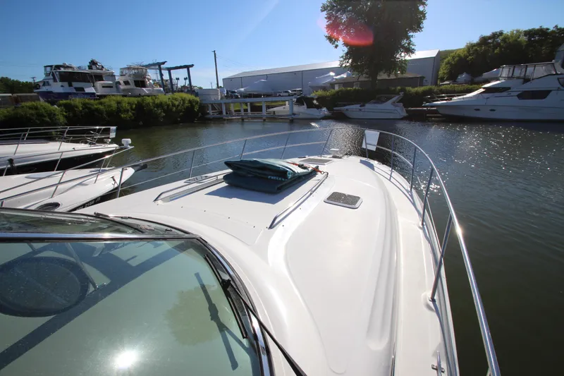 Slide: The Image of 2000 Sea Ray 410 Express Cruiser docked in a sunny marina. - 49