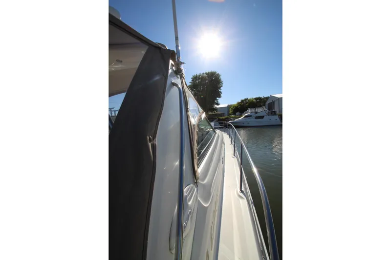 Slide: The Image of 2000 Sea Ray 410 Express Cruiser docked under bright sun. - 50