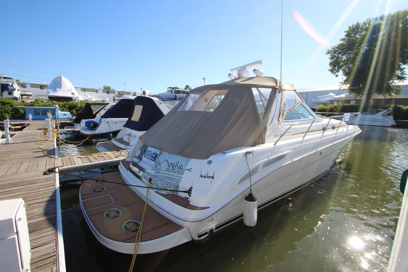 Slide: The Image of 2000 Sea Ray 410 Sundancer yacht on water with city skyline backdrop. - 54