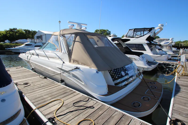Slide: The Image of 2000 Sea Ray 410 Sundancer yacht on water with city skyline background. - 55