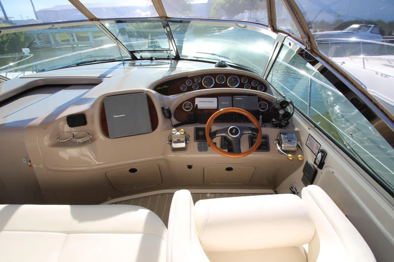 Slide: The Image of 2000 Sea Ray 410 Sundancer yacht on water with city skyline backdrop. - 57