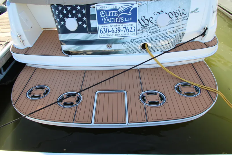 Slide: The Image of 2000 Sea Ray 410 Express Cruiser with teak swim platform and Elite Yachts LLC signage. - 58