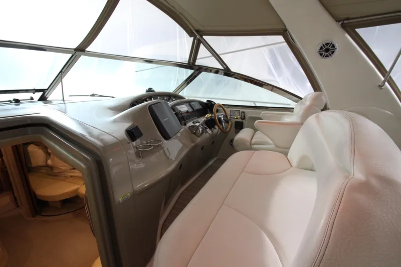 Slide: The Image of Interior cockpit of 2000 Sea Ray 410 Sundancer yacht with white seating and control panel. - 6