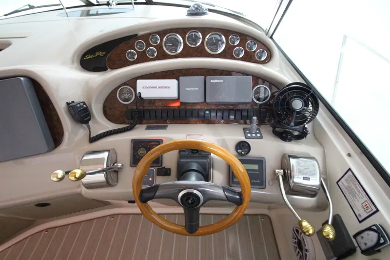 Slide: The Image of Control panel of a 2000 Sea Ray 410 Sundancer boat with steering wheel and gauges. - 9