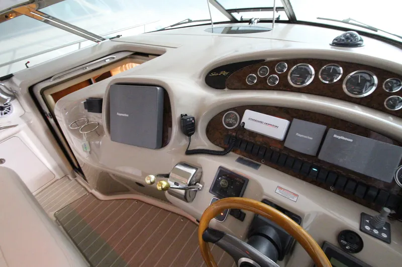 Slide: The Image of Helm of 2000 Sea Ray 410 Sundancer with navigation instruments and wood-accented steering wheel. - 11