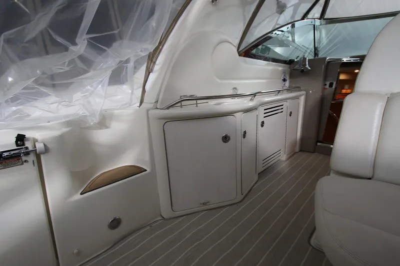 Slide: The Image of Interior of 2000 Sea Ray 410 Sundancer yacht, featuring sleek cabinetry and seating. - 19