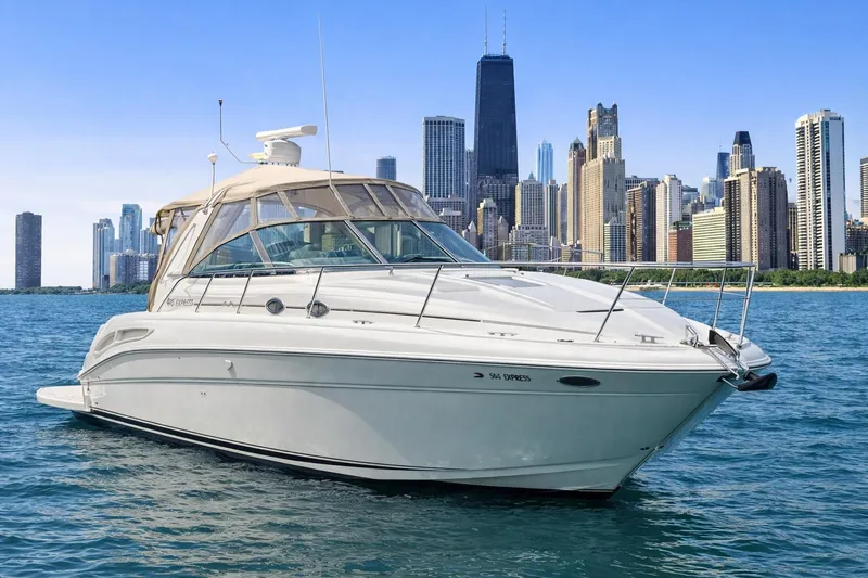 Slide: The Image of 2000 Sea Ray 410 Sundancer yacht on water with city skyline background. - 2