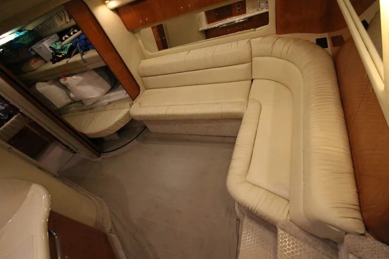 Slide: The Image of Interior of 2000 Sea Ray 410 Sundancer yacht with beige leather seating and wooden accents. - 27