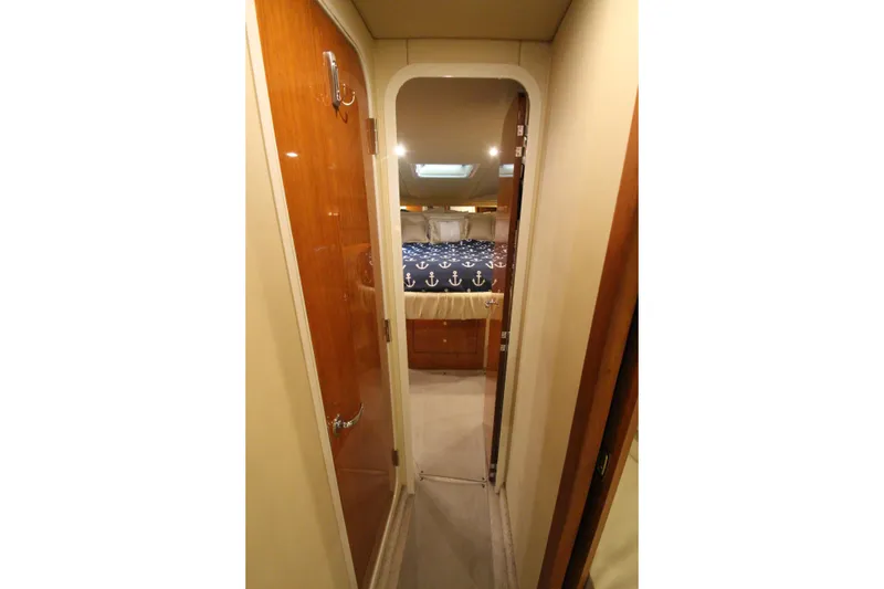 Slide: The Image of Interior hallway of 2000 Sea Ray 410 Sundancer yacht, leading to a cozy bedroom. - 29