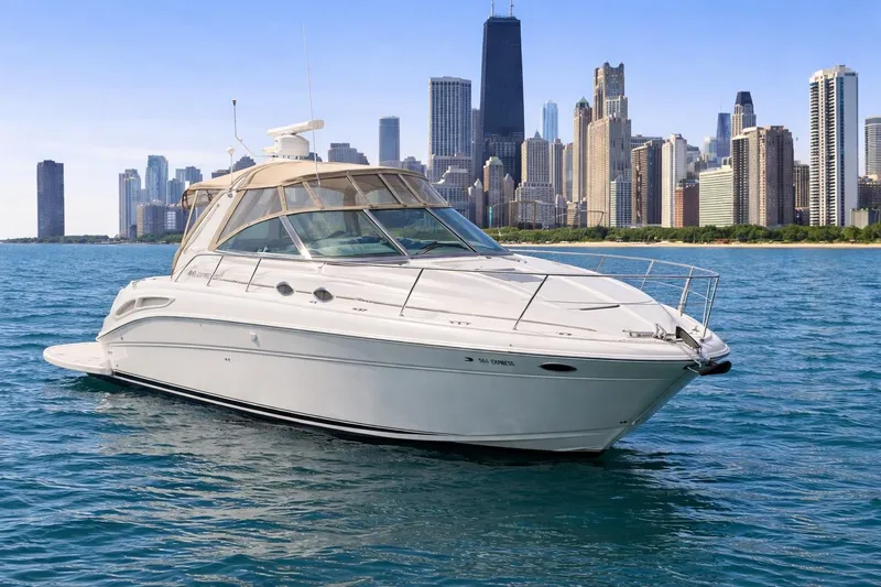 Slide: The Image of 2000 Sea Ray 410 Sundancer yacht on water with city skyline backdrop. - 3