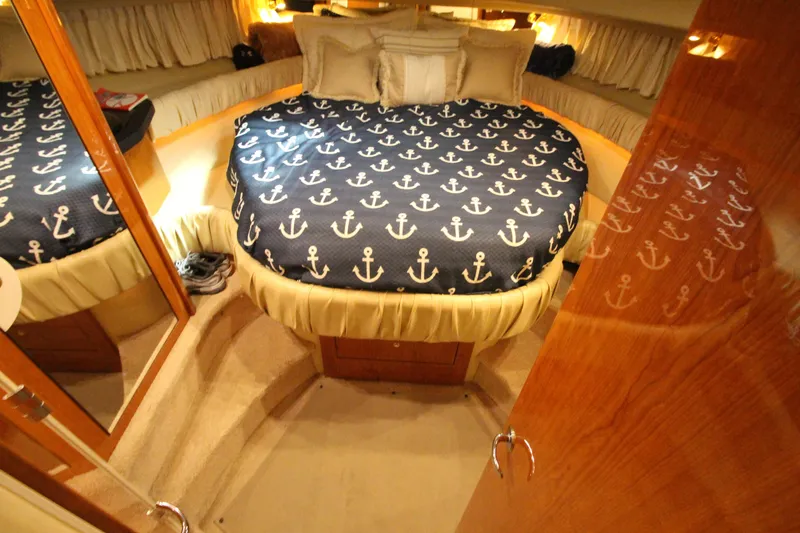 Slide: The Image of Luxurious cabin interior of 2000 Sea Ray 410 Sundancer yacht with anchor-themed bedding. - 30
