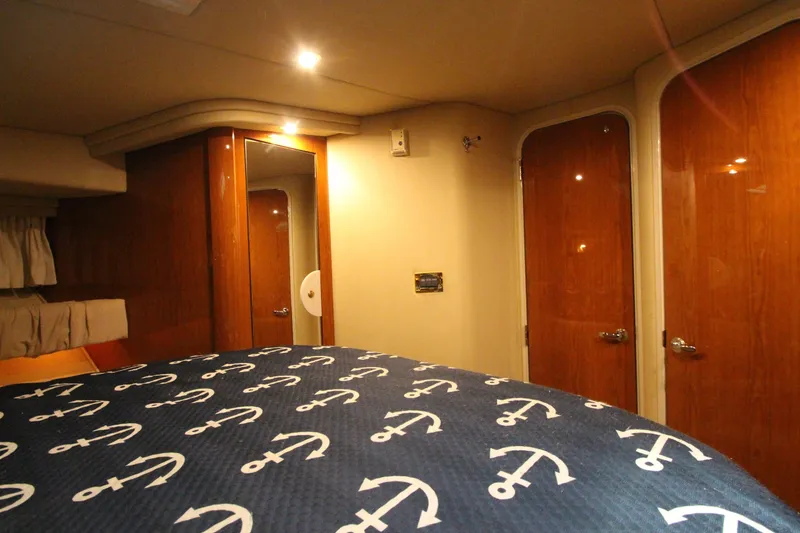 Slide: The Image of Interior cabin of 2000 Sea Ray 410 Sundancer with anchor-patterned bedding. - 37