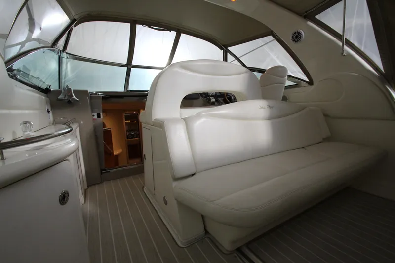 Slide: The Image of Interior of 2000 Sea Ray 410 Sundancer yacht with plush seating and helm. - 4
