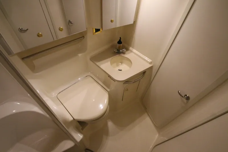 Slide: The Image of Compact bathroom in 2000 Sea Ray 410 Sundancer yacht, featuring sink and toilet. - 41