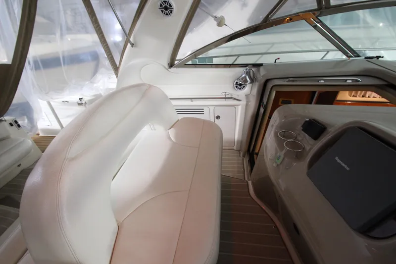Slide: The Image of Interior of 2000 Sea Ray 410 Sundancer yacht with white seating and control panel. - 8