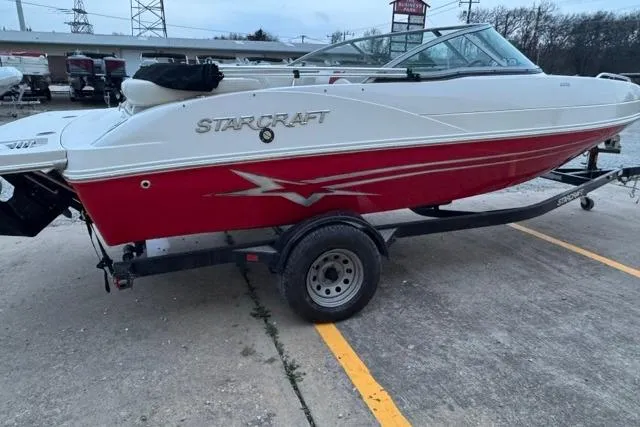 Slide: The Image of Red and white 2011 Starcraft 2018 IO Limited boat on trailer in parking lot. - 11