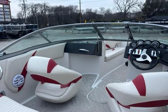 Slide: The Image of Interior of 2011 Starcraft 2018 IO Limited boat with red and white seating. - 5