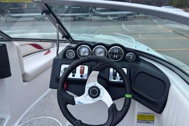 Slide: The Image of Steering console of 2011 Starcraft 2018 IO Limited boat with gauges and controls. - 6