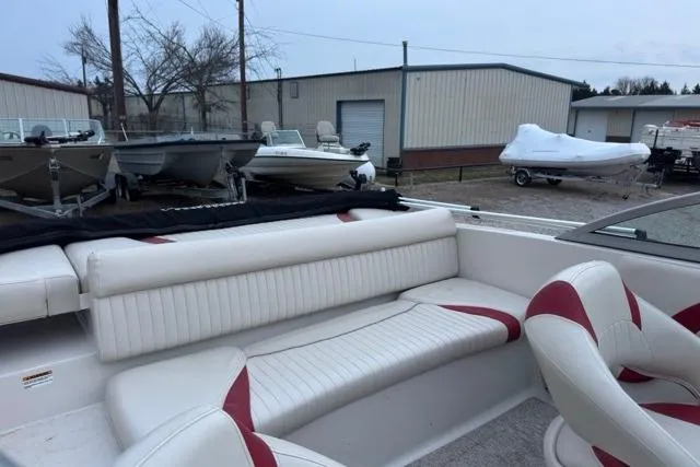 Slide: The Image of Interior of a 2018 Starcraft IO Limited boat with white and red seating. - 7