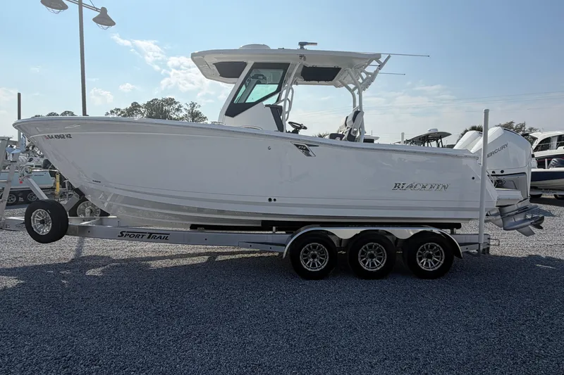 The Image of 2022 Blackfin 272 CC boat on a trailer, displayed outdoors. - 1