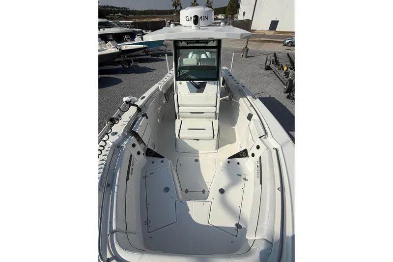 Slide: The Image of 2022 Blackfin 272 CC boat interior with Garmin equipment, docked outdoors. - 10