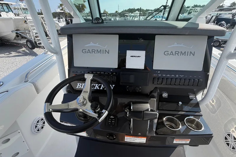 Slide: The Image of 2022 Blackfin 272 CC boat dashboard with Garmin displays and Mercury controls. - 15