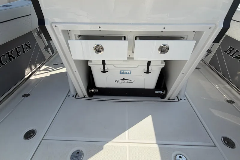 Slide: The Image of 2022 Blackfin 272 CC boat deck with Yeti cooler and storage compartments. - 17