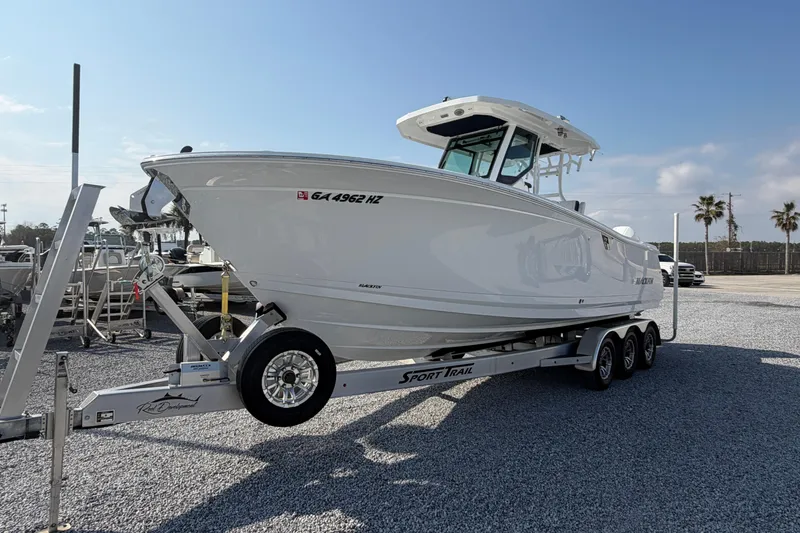 Slide: The Image of 2022 Blackfin 272 CC boat on trailer in sunny outdoor setting. - 3